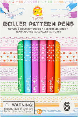 A colorful set of six Roller Pattern Pens by Tiger Tribe is displayed in a vibrant packaging. Each pen features unique patterns, including dots, stars, and hearts, in various bright colors like green, blue, pink, red, and orange. The packaging highlights fun designs that can be created with these pens, making them perfect for arts and crafts activities for kids aged 5 and up.