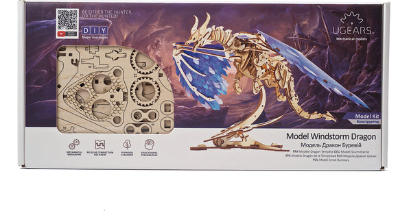 UGears 3D Windstorm Dragon model kit displayed in its packaging. The kit features intricately designed wooden pieces showcasing a dragon with blue wings, gears, and other components. Ideal for DIY enthusiasts, this mechanical model is perfect for educational and creative projects.
