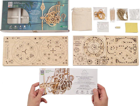 A hands-on DIY kit featuring the UGears 3D Aero Clock with pendulum. The image shows the assembled clock kit alongside individual components including wooden pieces, rubber bands, and assembly tools. The packaging displays intricate designs and a window showing parts of the clock mechanism, inviting builders to enjoy the crafting experience.