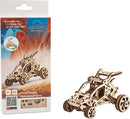 The Ugears 3D Mini Desert Buggy is a detailed DIY kit featuring an intricate wooden model of an off-road vehicle. The kit comes partially assembled, displayed alongside its colorful packaging that highlights its playful design and ease of assembly. Suitable for ages 8 and up, this mechanical puzzle encourages creativity and hands-on building experiences.