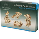 U-Fidgets Pacific Ocean DIY kit by Ugears. This set includes intricately designed mechanical models resembling ocean creatures such as fish and seahorses. The wooden pieces are crafted to showcase detailed patterns, perfect for enhancing creativity and dexterity. Ideal for both children and adults who enjoy building and fidgeting.