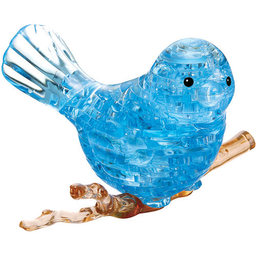 A 3D crystal jigsaw puzzle of a blue bird, intricately designed with transparent and translucent parts. The bird is perched on a brown branch, showcasing detailed craftsmanship and a vibrant blue color that catches the light beautifully.