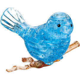 A 3D crystal jigsaw puzzle of a blue bird, intricately designed with transparent and translucent parts. The bird is perched on a brown branch, showcasing detailed craftsmanship and a vibrant blue color that catches the light beautifully.