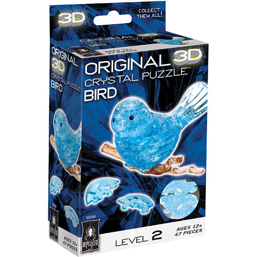 3D Crystal Puzzle Blue Bird by bePuzzled. This jigsaw puzzle features 47 translucent blue pieces that fit together to create a stunning crystal-like bird, perched on a branch. The packaging highlights its level 2 difficulty and is suitable for ages 12 and up, featuring vibrant graphics and a clear depiction of the completed puzzle.
