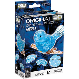 3D Crystal Puzzle Blue Bird by bePuzzled. This jigsaw puzzle features 47 translucent blue pieces that fit together to create a stunning crystal-like bird, perched on a branch. The packaging highlights its level 2 difficulty and is suitable for ages 12 and up, featuring vibrant graphics and a clear depiction of the completed puzzle.
