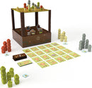 Mountains Out of Molehills game by USAopoly featuring a multi-layered game tower filled with various colorful building tokens. Surrounding the tower are game cards, player pieces, and stacks of tokens in different colors, ready for players to build and strategize.