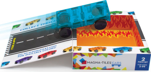 The Magna Tiles Cars 2 Piece Expansion Set features a transparent blue car rolling over a printed race track background and a vibrant fire-themed insert. The packaging highlights the colorful cars available for collection, ideal for creative play and learning.