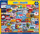 A colorful jigsaw puzzle titled 'A Day at the Beach' by White Mountain Puzzles, featuring nostalgic beach-themed illustrations with signs and logos from various beach locations across the USA. The puzzle consists of 1000 pieces and includes a bonus poster inside.