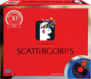 Scattergories 30th Anniversary game box by Winning Moves. The box is bright red with a playful design featuring a stylized head and colorful elements symbolizing thoughts. It includes a mechanical timer for gameplay, with bold text reading 'The Game of Scattergories' prominently displayed.