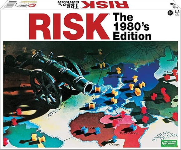 The 1980's Edition of the classic board game Risk by Winning Moves. The game box features a colorful world map with strategic territories outlined. A cannon is shown alongside various colored game pieces representing armies, highlighting the game's theme of global conquest and strategy.