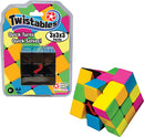The Twistables 3x3x3 puzzle by Winning Moves features a vibrant design with colorful squares in pink, yellow, green, and blue. The puzzle is partially twisted to display its mechanical function, emphasizing quick turns and easy solving. Packaging is visible, highlighting the product name and features, along with a warning for appropriate age.