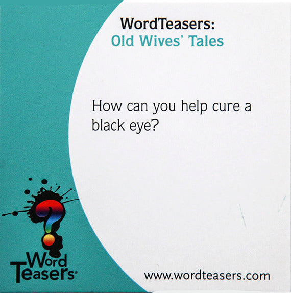 The Word Teasers game titled 'Old Wives' Tales'. The image shows a card with the title at the top, followed by the question 'How can you help cure a black eye?' This card is part of a game designed to spark conversation and challenge players on old wives' tales.