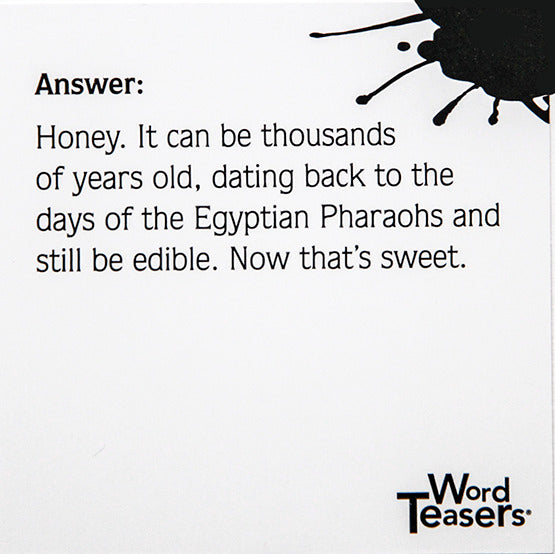 A close-up of a Word Teasers Random Knowledge card featuring an intriguing answer about honey. It elaborates on honey's age, noting it can be thousands of years old, dating back to the Egyptian Pharaohs, and still be edible. The card is decorated with a black ink splash design, embodying a playful and engaging learning experience.