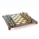 Elegant Cycladic Art Chess Set by Manopoulous featuring intricate sculptured pieces and a beautifully designed board. The board is accented with shiny gold and deep brown tones, making it a stunning addition to any game collection.