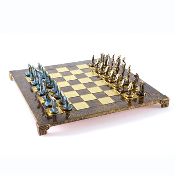 Elegant Cycladic Art Chess Set by Manopoulous featuring intricate sculptured pieces and a beautifully designed board. The board is accented with shiny gold and deep brown tones, making it a stunning addition to any game collection.