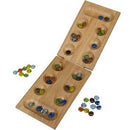 A wooden Mancala game set laid open, featuring a smooth, rectangular board with two rows of pits for marbles. Colorful glass marbles in various shades are scattered around the board, showing vibrant hues of blue, green, amber, and more. The set is neatly arranged for gameplay, evoking a sense of strategy and fun.
