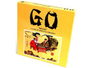 Go Set W/Wood Board by John N. Hansen Co. Inc. is a deluxe game of Go featuring traditional artwork. The bright yellow box showcases an illustration of two players engaged in the strategy game, emphasizing its cultural significance and elegant design.