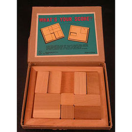 Vintage 'What's Your Score?' mechanical puzzle by Nick Baxter, featuring a box with a colorful design. Inside the box, there are several wooden pieces arranged in a grid, designed for challenging spatial reasoning and problem-solving. The game encourages players to fit the pieces into the outlined areas on the lid, providing an engaging brain teaser experience.