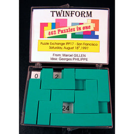 TwinForm IPP 17 Mechanical Puzzle featuring 462 unique puzzle configurations, presented in a clear, compact box designed by Marcel Gillen. The pieces are vibrant green, arranged neatly in a grid with a label indicating the date and event of the Puzzle Exchange in San Francisco.