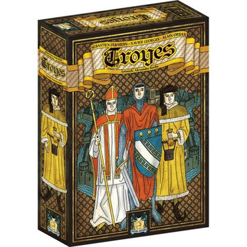 The 'Troyes' game by Asmodee, featuring an illustrated box depicting three medieval characters: a bishop in a red mitre, a nobleman in a blue outfit, and a man in a yellow cloak. The background showcases a stylized depiction of medieval architecture and a castle, indicating the historical theme of the game.