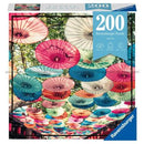 Ravensburger Puzzle Moments: Umbrellas, a 200-piece jigsaw puzzle featuring colorful paper umbrellas suspended from tree branches. The vibrant color palette includes shades of red, pink, blue, and yellow, creating a cheerful and lively scene. Ideal for family fun and a creative way to spend time indoors.