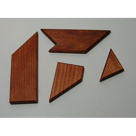 Nine House 'T' mechanical puzzle by Here to There Companies, featuring four intricately shaped wooden pieces that challenge spatial reasoning and problem-solving skills.