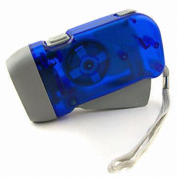 A hand-powered flashlight made by Hansfull Trading Company, featuring a blue translucent casing with grey accents. The device is compact, designed for portability, and includes a strap for easy carrying. Ideal for outdoor activities and emergency situations, this practical tool does not require batteries, making it eco-friendly and convenient.