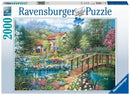 The 'Shades of Summer' jigsaw puzzle by Ravensburger features a vibrant, picturesque scene of a charming house surrounded by a lush garden filled with colorful flowers and a serene stream with a wooden bridge. The artwork is designed with intricate details and rich colors, capturing the essence of summer tranquility. This 2000-piece jigsaw puzzle is perfect for puzzle enthusiasts and nature lovers.