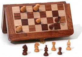 7-inch magnetic folding chess set by R. Expo, showcasing a wooden board with alternating light and dark squares. The board is open to display pieces, including pawns, knights, bishops, rooks, and a king, arranged on the board. The set exhibits a compact design, perfect for travel or casual play, featuring pieces made from wood and a sturdy folding case.