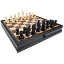 A beautifully crafted 3.5 inch black chess set featuring an elegant wooden board with black and natural colored squares. The board includes a compartment for storing pieces. Black and natural wooden chess pieces are arranged, showcasing kings, queens, knights, and pawns, ready for a game of strategy and intellect.