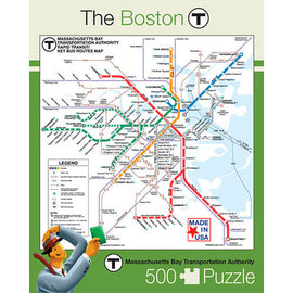 A 500-piece jigsaw puzzle featuring a detailed map of the Boston T transportation system, highlighting subway and bus routes with colorful lines. The design includes a legend for easy navigation and is made in the USA by New York Puzzle Company. The background is light with a playful character holding a puzzle piece, set against the map layout.