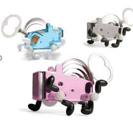 A collection of three whimsical windup creatures in various colors including pink, blue, and clear. Each creature features a winding key, playful legs, and a charming design that showcases its mechanical nature, ideal for engaging hands-on play.