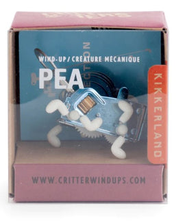 A whimsical wind-up toy named Pea, designed by Kikkerland Design Inc. The toy is a mechanical creature with a shiny blue body and flexible white limbs. It is displayed in a colorful package that features the product title and brand logo, ideal for collectors and toy enthusiasts.