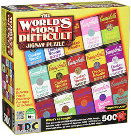 The World's Most Difficult Jigsaw Puzzle by TDC Games Inc, featuring a vibrant array of colorful Campbell's soup cans. This 500-piece puzzle is labeled 'Souper Hard' and offers an extreme challenge for ages 12 and up. The box shows the unique double-sided design with the same image rotated 90 degrees, ensuring every piece fits both ways, making it a true test of skill and patience.