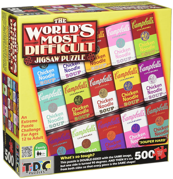 The World's Most Difficult Jigsaw Puzzle by TDC Games Inc, featuring a vibrant array of colorful Campbell's soup cans. This 500-piece puzzle is labeled 'Souper Hard' and offers an extreme challenge for ages 12 and up. The box shows the unique double-sided design with the same image rotated 90 degrees, ensuring every piece fits both ways, making it a true test of skill and patience.