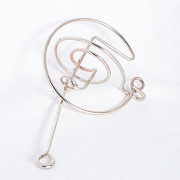 The Comet mechanical puzzle by Eureka Puzzles features a sleek, spiral design crafted from shiny metal. Its intricate twists and turns challenge users to navigate a small ball through the maze, making it a fun and engaging brain teaser for puzzle enthusiasts.