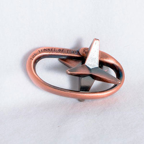 The Time Tunnel Mechanical puzzle by Eureka Puzzles is an intricate metal puzzle shaped like an infinity loop with a star-shaped element in the center. The design features a blend of shiny silver and warm copper tones, showcasing a captivating and modern aesthetic that invites exploration and problem-solving.