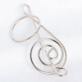 The G-Clef Puzzle by Eureka Puzzles is a unique mechanical puzzle designed in the shape of a treble clef. Made of durable metal, it features intricate loops and curves, inviting users to engage in a challenging experience as they work to untangle its structure. Ideal for music lovers and puzzle enthusiasts, this captivating piece combines artistry with brain-teasing fun.