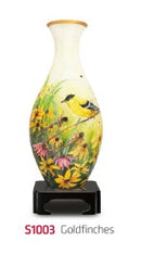 A beautifully crafted 3D jigsaw puzzle in the shape of a vase featuring a design with singing goldfinches and vibrant flowers. The vase is displayed on a black stand, showcasing its artistic details and colorful imagery, perfect for puzzle enthusiasts and decor lovers.