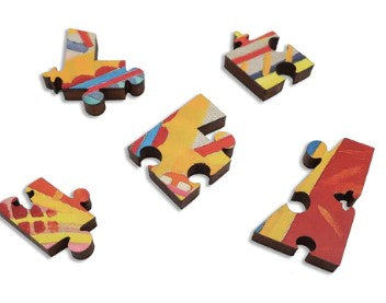 Colorful wooden jigsaw puzzle pieces inspired by Robert Delaunay's Eiffel Tower artwork. The pieces vary in shape and feature vibrant colors such as yellow, red, and blue, showcasing abstract patterns intended to engage puzzlers both visually and intellectually.