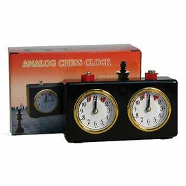 Wind-Up Analog Chess Clock from WorldWise Imports featuring two dials for tracking time in chess games. The black clock has a classic design with gold accents, and comes in a decorative box. Ideal for chess enthusiasts seeking an authentic experience.