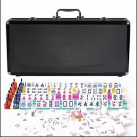 A sleek black aluminum case containing a Mah Jongg set. The case is closed with a sturdy handle on top. Inside, colorful tiles are arranged in neat rows, showcasing various designs, along with a set of bright red, blue, and green player tokens and a few score markers. The entire set is meticulously organized for easy access and transport, perfect for game nights with family and friends.