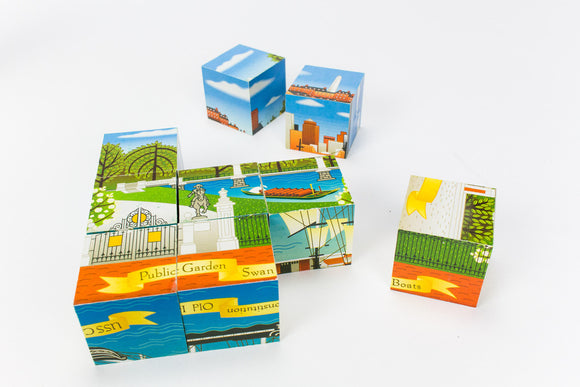 Boston City Squares jigsaw puzzle showcasing charming illustrations of iconic Boston landmarks, including parks, boats, and skyline vistas. The vibrant pieces are scattered for assembly, inviting puzzle enthusiasts to experience the beauty of Boston.