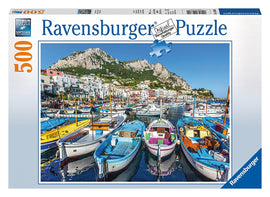 Ravensburger Colorful Marina jigsaw puzzle featuring a vibrant port scene with beautifully colored boats docked in a serene harbor, surrounded by picturesque buildings and mountains in the background. The puzzle contains 500 pieces, enriching your leisure time with a captivating image.