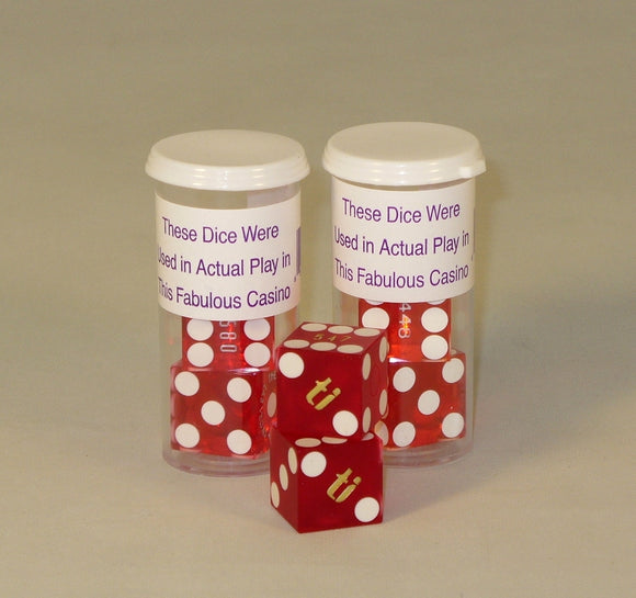 Casino Precision Dice Set of 2 includes two transparent containers with red dice featuring white dots and letters, labeled to indicate they were used in actual casino play. The dice are designed for gaming enthusiasts seeking an authentic casino experience.