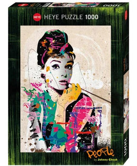 Heye jigsaw puzzle featuring a colorful pop art design of Audrey Hepburn, designed by artist Johnny Cheuk. The puzzle contains 1000 pieces and comes in a vibrant box showcasing the artwork, ideal for puzzle enthusiasts and fans of classic cinema.