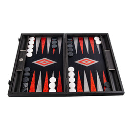 An elegant 19-inch black oak backgammon set with silver accents, featuring a vibrant game board design in red, black, and grey, along with smooth black and white pieces. The set is open, displaying an ongoing game, showcasing its intricate craftsmanship.