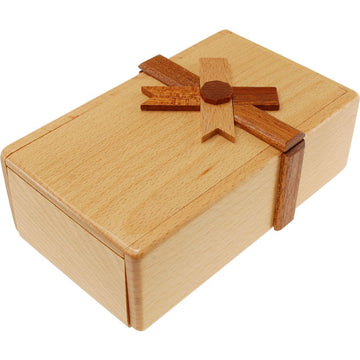 The Secret Opening Box 3 by Puzzle Master is a beautifully crafted mechanical puzzle box made from high-quality wood. It features a charming design resembling a gift box, complete with a wooden ribbon and bow detailing. The light-colored wood has a smooth finish, and the box is compact and sturdy, perfect for engaging puzzles or hiding small treasures inside. Its intricate locking mechanism adds an exciting challenge for puzzle enthusiasts seeking to unlock its secrets.