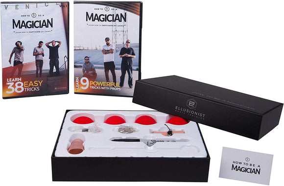 A boxed set titled 'How To Be A Magician' by US Playing Card Co., featuring two instructional DVDs and a collection of magician props including red balls and a wand. The packaging displays the Ellusionist logo and various tools needed for performing magic tricks.