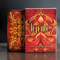 Ignite Deck playing cards by US Playing Card Co. featuring vibrant red and gold designs on the front and back. The intricate patterns and elegant typography make it a visually stunning addition to any game night.